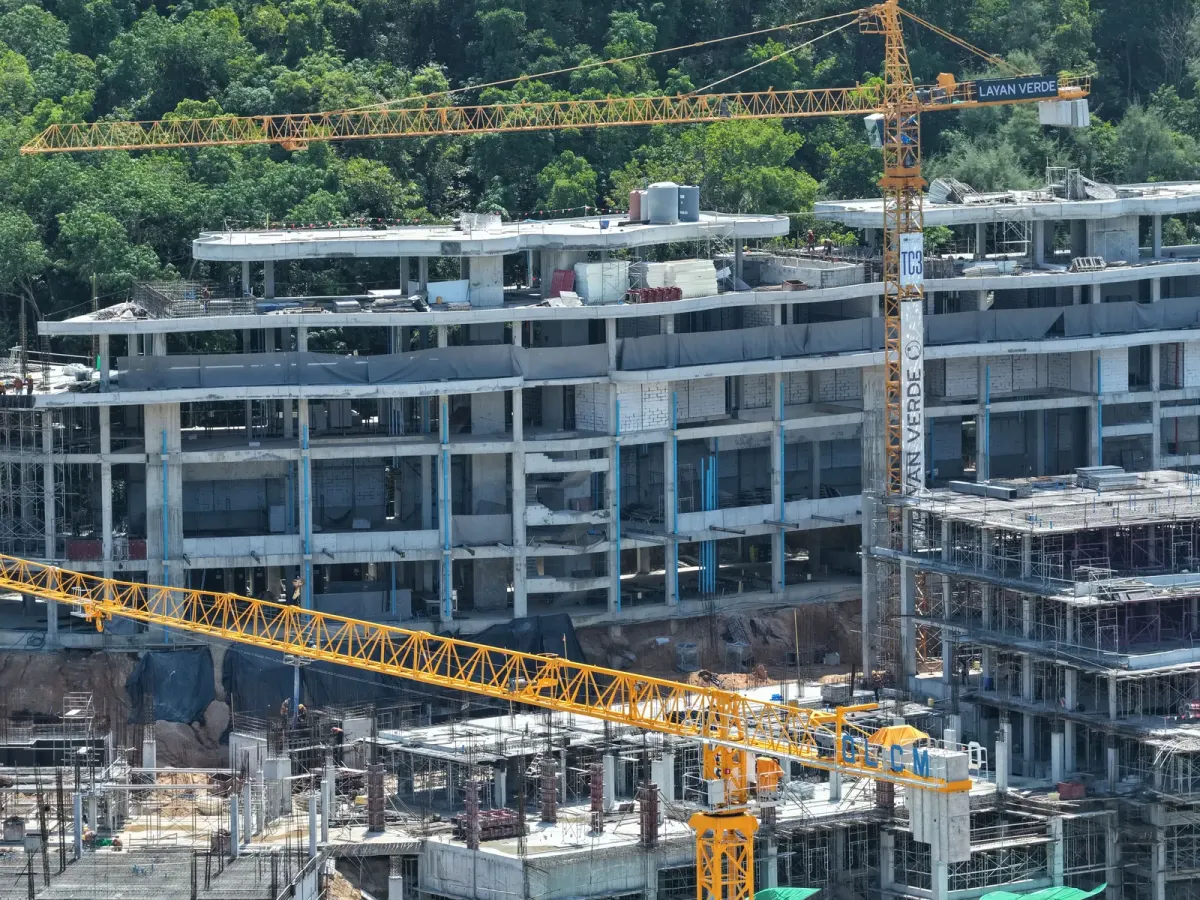Construction work on upper floors of a Phuket condominium building under development Construction work on upper floors of a Phuket condominium building under development